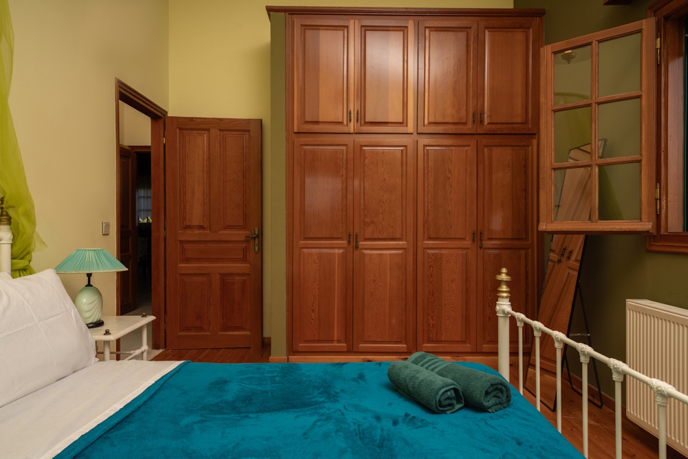 Bedroom with wooden wardrobe at Selini Villa in Kalithea