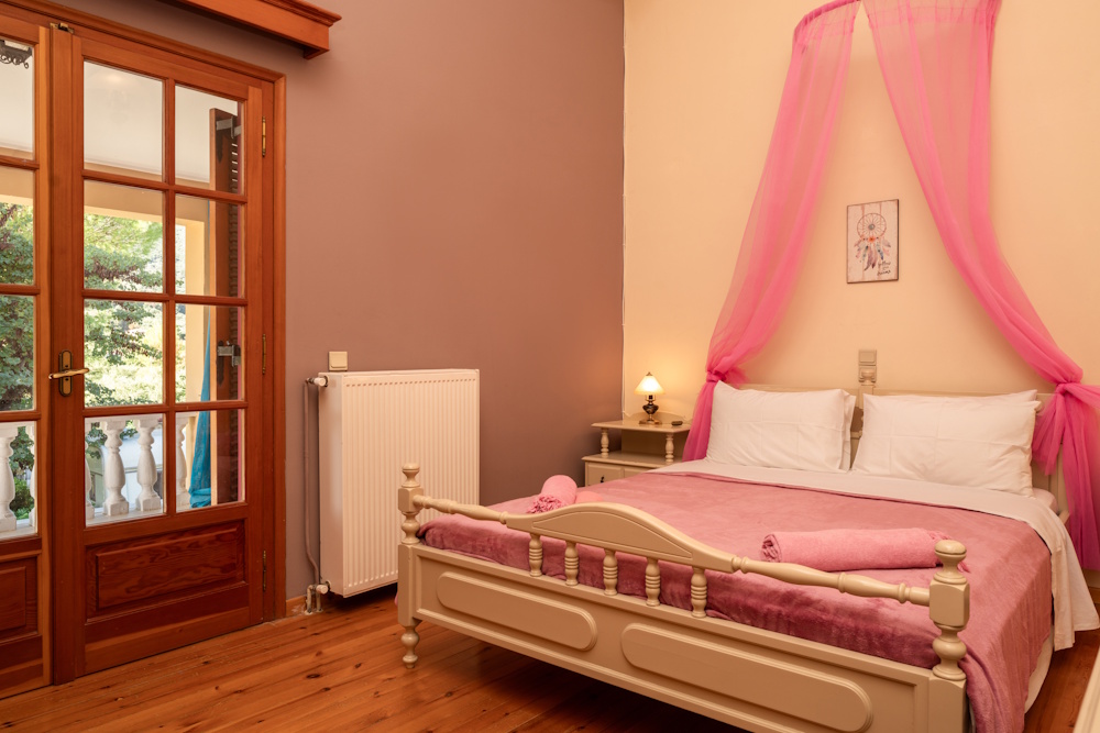 Bedroom with balcony door at Selini Villa in Kalithea