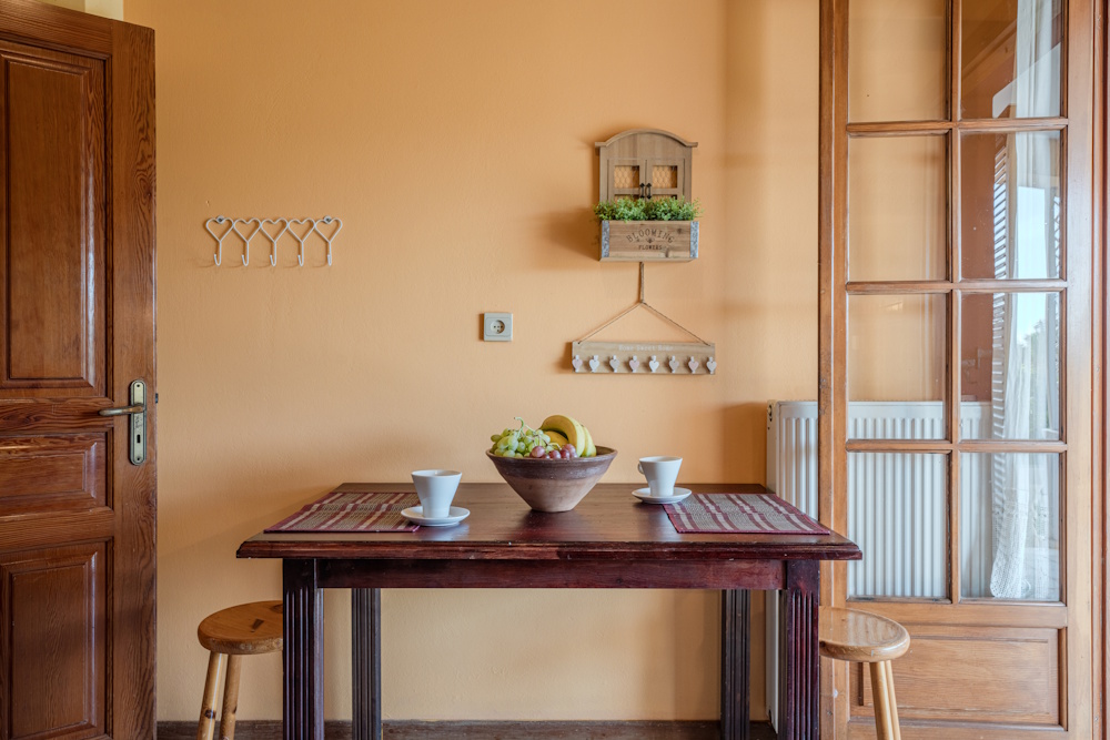 Interior dining table with wooden details at Selini Villa in Kalithea